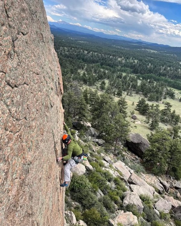 Brian climbing a granite face